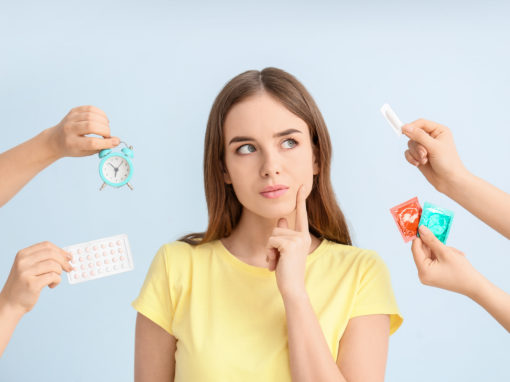 woman surrounded by birth control methods thinking about which to choose